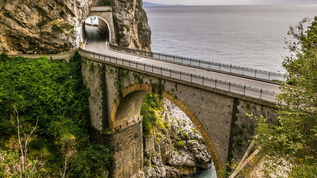 fiordo di furore Amalfi Coast (Costiera Amalfitana) Italy beach between the rocks in the gorge. Beautiful bridge on the top. traffic cars on the bridge. 4K video footage timelapse