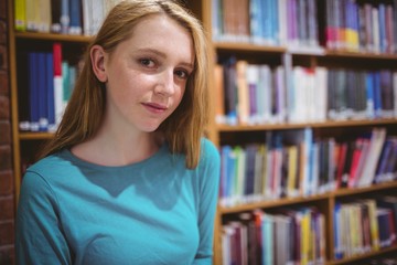 Blond student in library looking at the camera