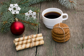 coniferous branch, two linking of cookies and coffee