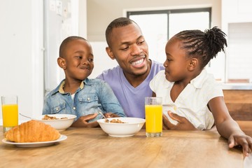 Casual happy family having breakfast