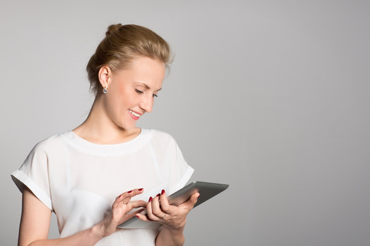 Smiling business woman with a tablet PC