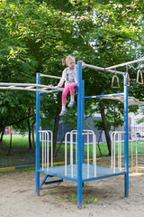 Fototapeta premium little girl sit on top of street athletic complex