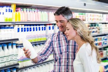 Smiling couple buying milk