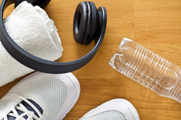 sport concept. headphones, shoes and water in bottle