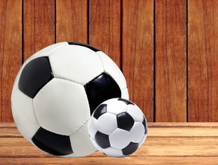 soccer (football) balls on wooden table