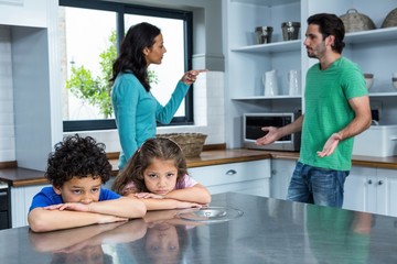 Sad children listening to parents argument