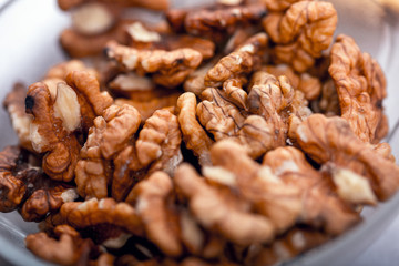 Heap of raw walnuts close-up as background.