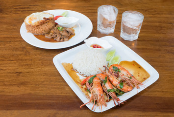 Spicy Shrimp with Basil Leaves Source and Fried Rice with Chicken Source On The Wood Table