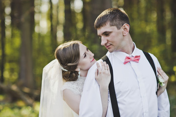 The wife embraces her husbands shoulders in the woods 4115.