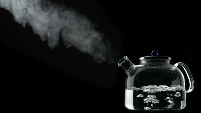 Boiling water in kettle on black background shooting with high speed camera, phantom flex.
