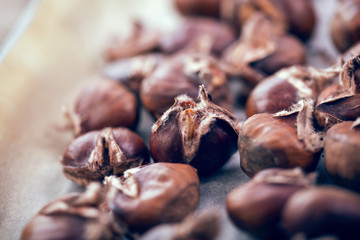 Healthy winter snack chestnuts on wooden background, selective focus