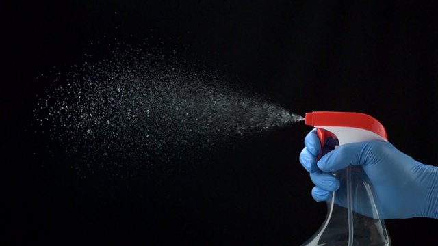 Using spraying bottle and cleaning on black background shooting with high speed camera, phantom flex.