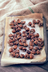 Healthy winter snack chestnuts on wooden background, selective focus