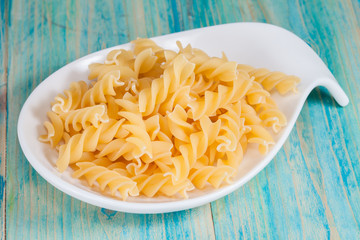 Raw spiral macaroni in plate