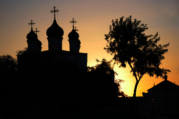 Orthodox church and birch silhouette at sunset, russian stereotypical symols Astrakhan Russia