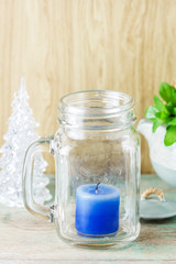 Blue candle in bottle glass