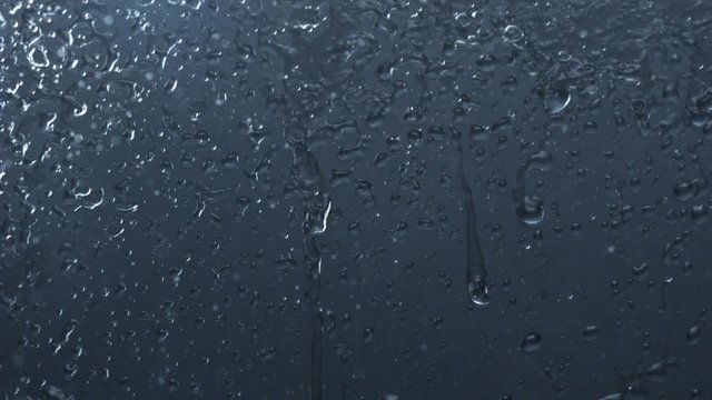 Water dripping down on window glass shooting with high speed camera, phantom flex.