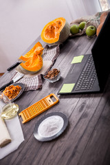 Preparing pie with pumpkins on wooden table