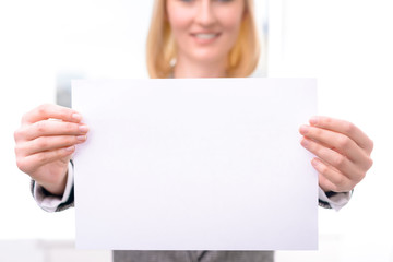 Professional businesswoman holding sheet of paper 