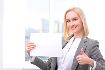 Naklejka premium Professional businesswoman holding sheet of paper 