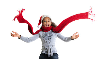 cheerful dark-skinned girl in a red scarf and hat of Santa Claus. Winter portrait of joyful adolescent girls