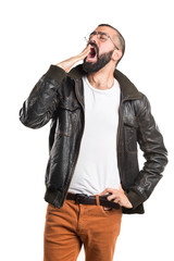 Man with leather jacket yawning