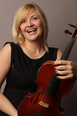 the young cheerful beautiful girl the musician playing a violin