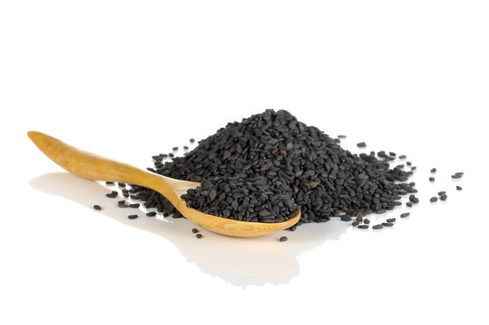 Heap of black sesame on wooden spoon