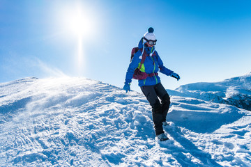 woman descending from snowy mountains