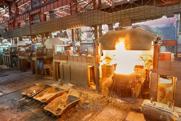 Fototapeta na wymiar Metal smelting furnace in steel mills