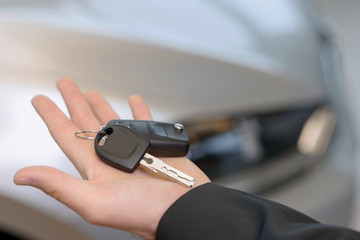 Car keys in salesclerks open hand. 