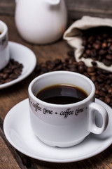 Coffee cup and coffee beans on table