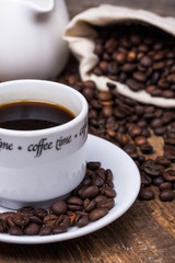 Coffee cup and coffee beans on table