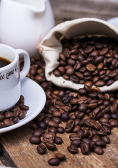 Coffee cup and coffee beans on table