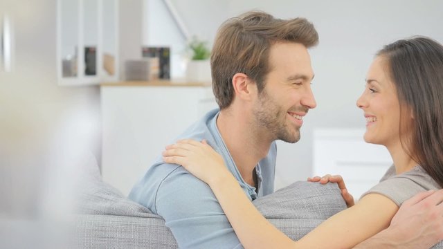 Young in love couple relaxing in sofa