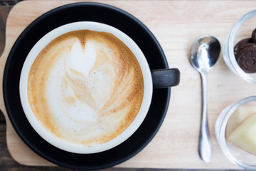 Coffee cup on wooden table. View from top