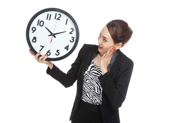 Young Asian business woman surprised with a clock