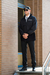 Male Security Guard Standing At The Entrance