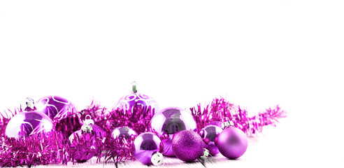 Pink Christmas tree balls and decorations isolated on white background