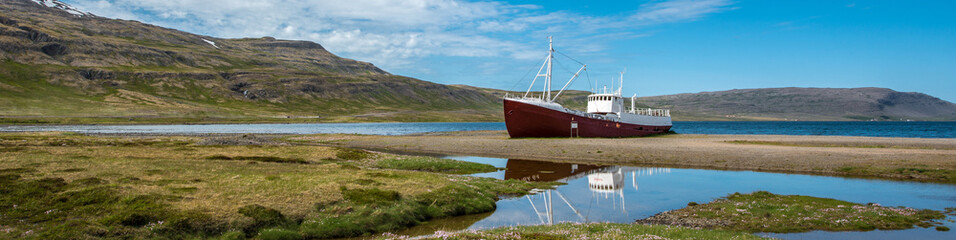 Old boat on a beach in Patreskfjordur, Westfjords, Iceland