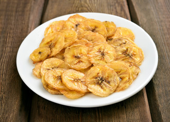 Banana chips on white plate