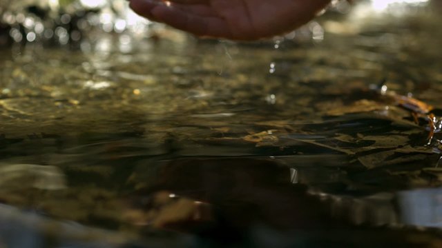 Scoop up a handful of water from creek shooting with high speed camera, phantom flex.