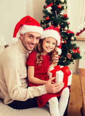 smiling father and daughter holding gift box