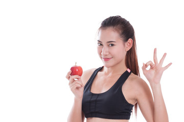 Fitness woman holding apple and showing ok sign. healty concept