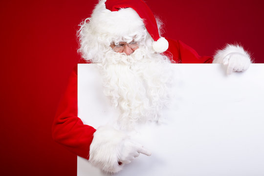 Santa Claus pointing in white blank sign with smile,christmas  r