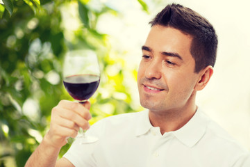 happy man drinking red wine from glass