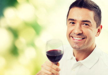 happy man drinking red wine from glass