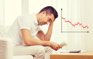 Obraz premium man with money and calculator at home