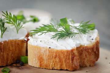 crunchy baguette slices with cream cheese and herbs