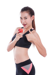 Fitness woman holding apple and showing thumb up.